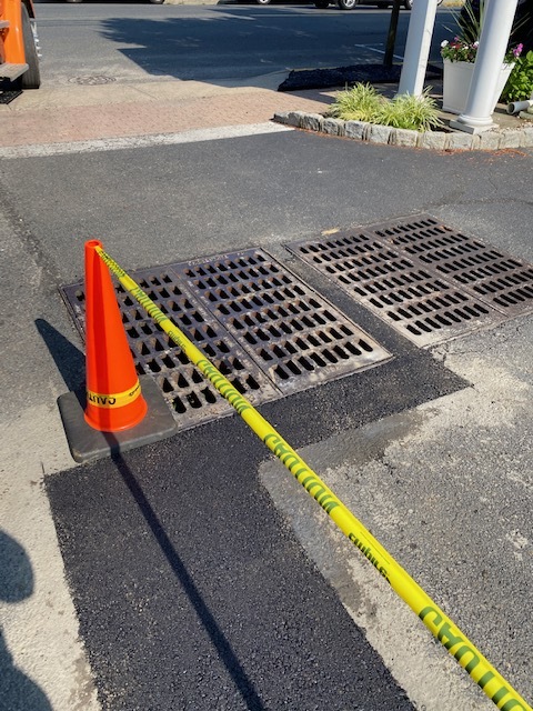 Finished asphalt repair around storm drain grates